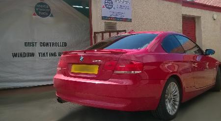 BMW 3 Series Coupé with limo black window tints on rear windows.  Dust controlled window tinting booth with the wind barrier closed can be seen in the background. Eddie's Window Tints Wishaw 01698 640697