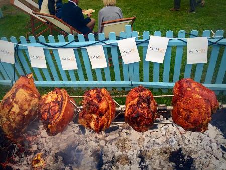 Spit roast pork legs cooking over charcoal by The Fabulous Barbecue The Fabulous Barbecue Wix 01394 670739