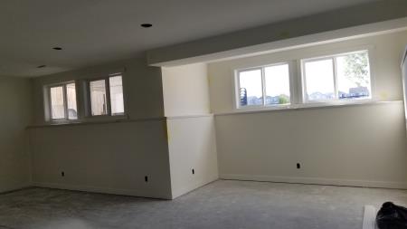 an airdrie basement development including framing ducting bulkheads, smooth ceiling with clean pot lights, mdf ledge capping along exterior wall ledge.  MD-DRYWALL Incorporated Airdrie (403)880-4767