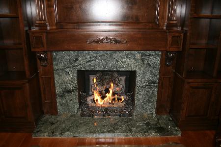 Custom fireplace mantle, book shelves, and granite face. Performance Construction & Remodeling Inc. Chino Hills (714)655-6427